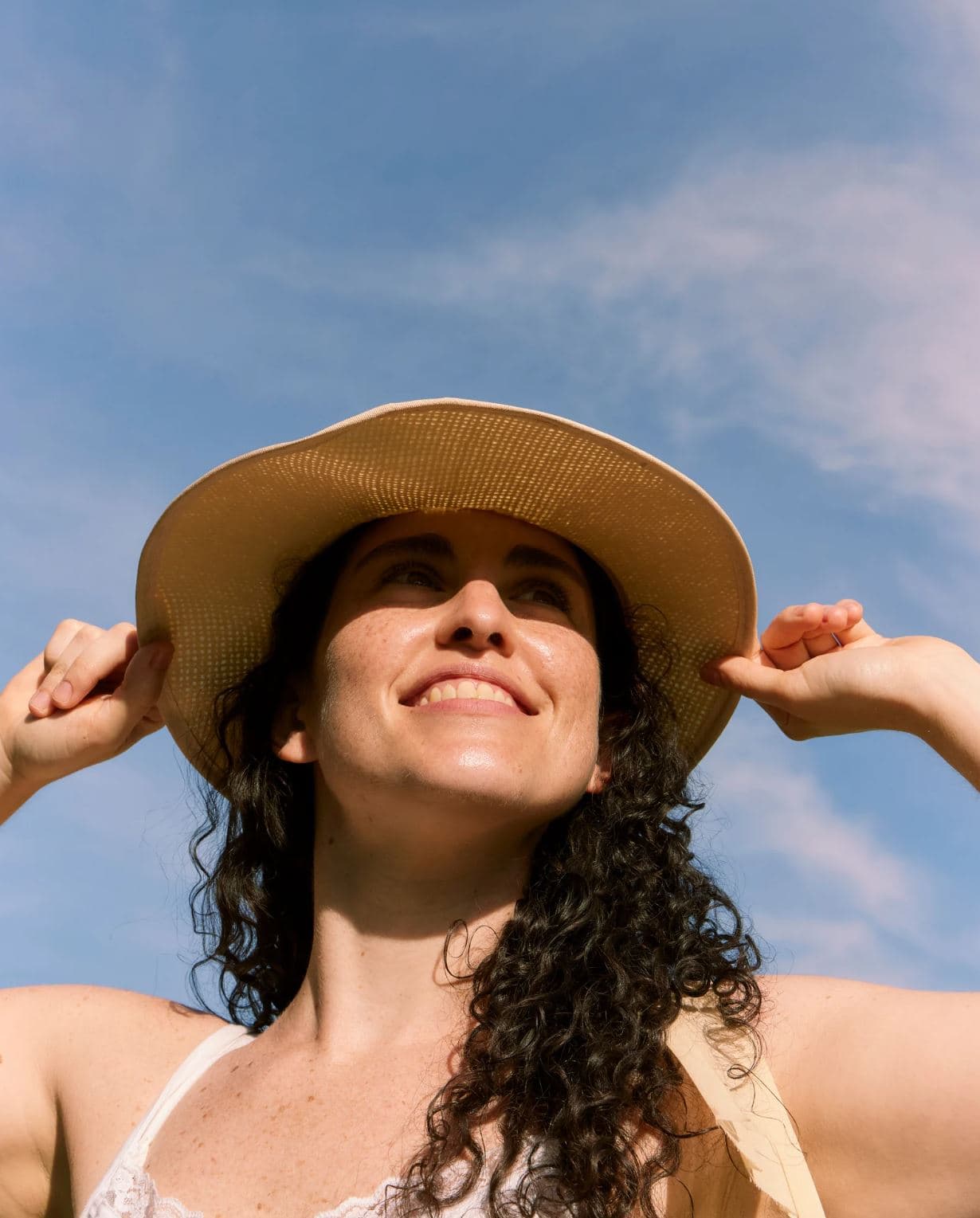 Woman in a sun hat enjoying the summer sun